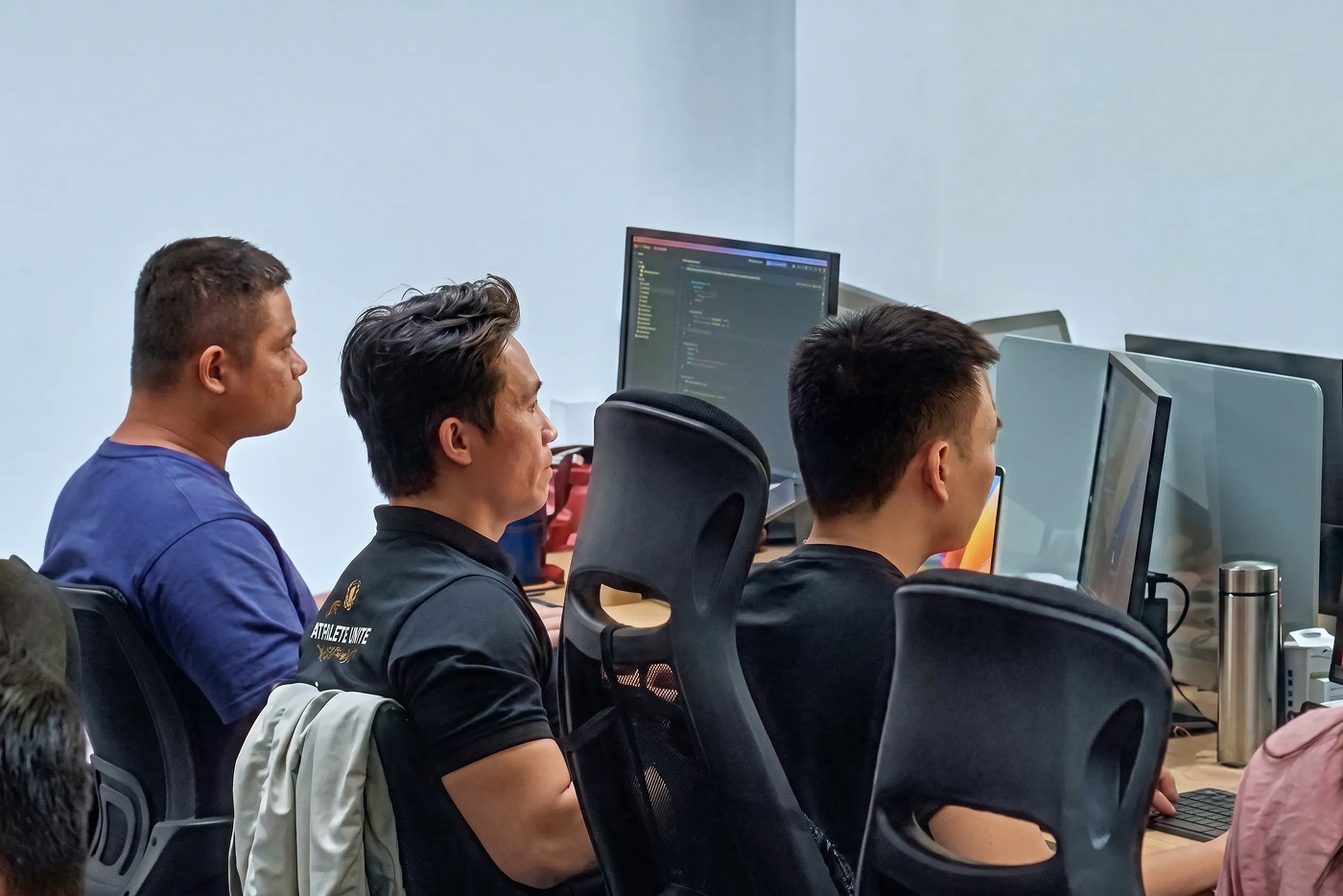Engineers reviewing code together at a workstation